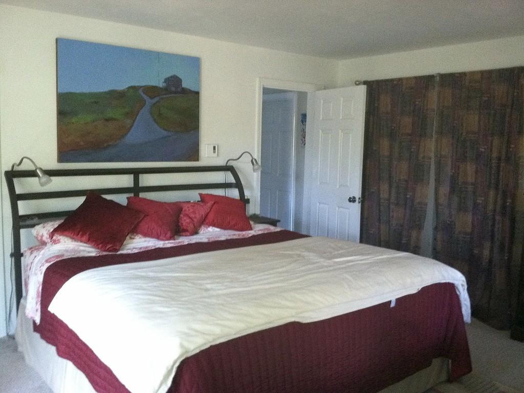 26 Fishermans Road Truro, MA 02666 - Photo 9 of 29 a bedroom with a bed and painting on the wall