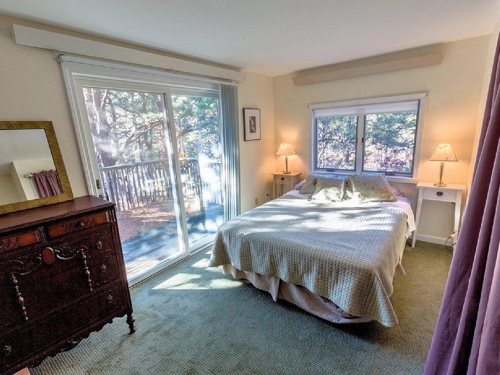 26 Fishermans Road Truro, MA 02666 - Photo 10 of 29 a bed sitting in a room next to a window