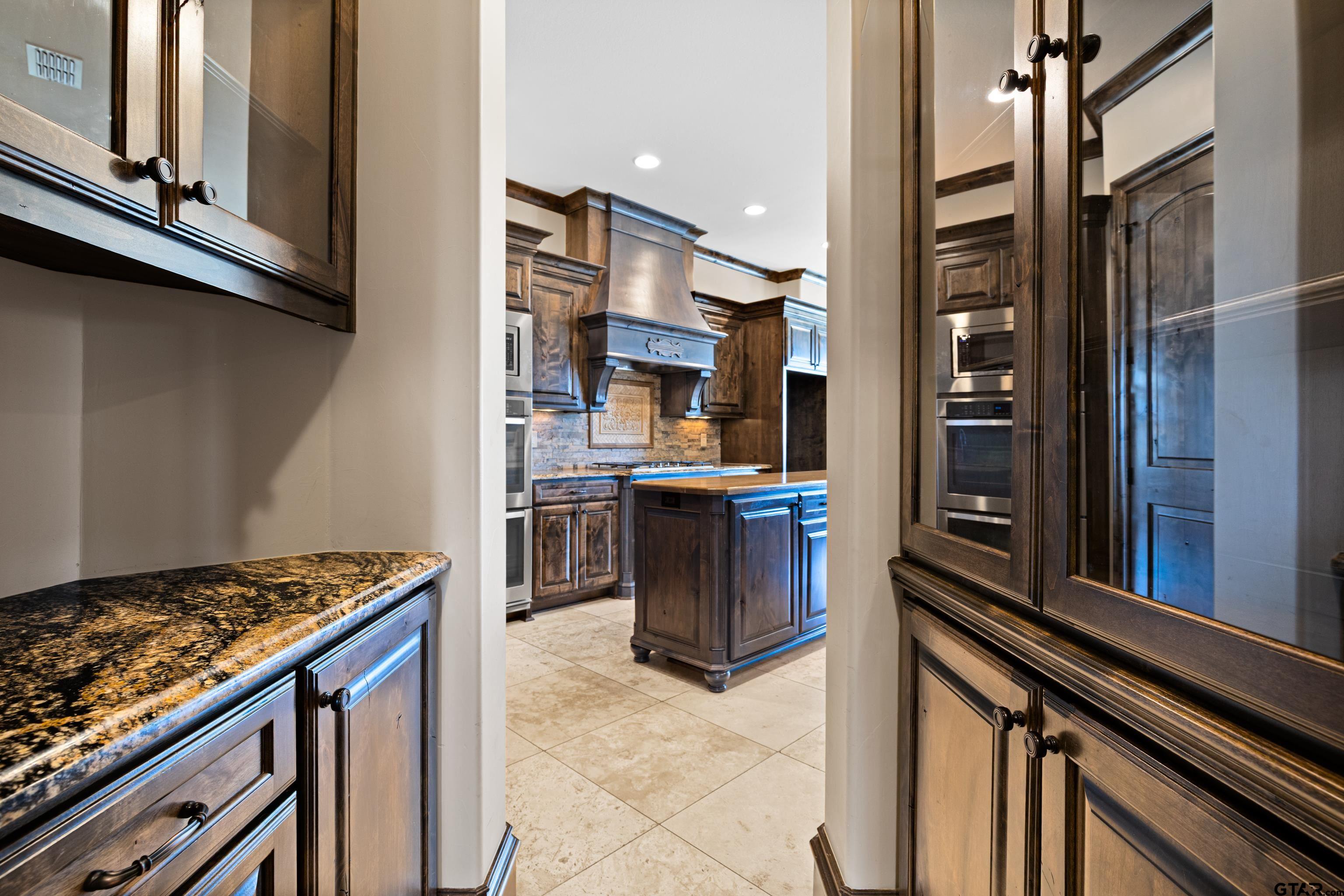 4314 Pecan Ridge Crossing Longview, TX 75605 - Photo 20 of 47 a kitchen with stainless steel appliances granite countertop a stove and a refrigerator