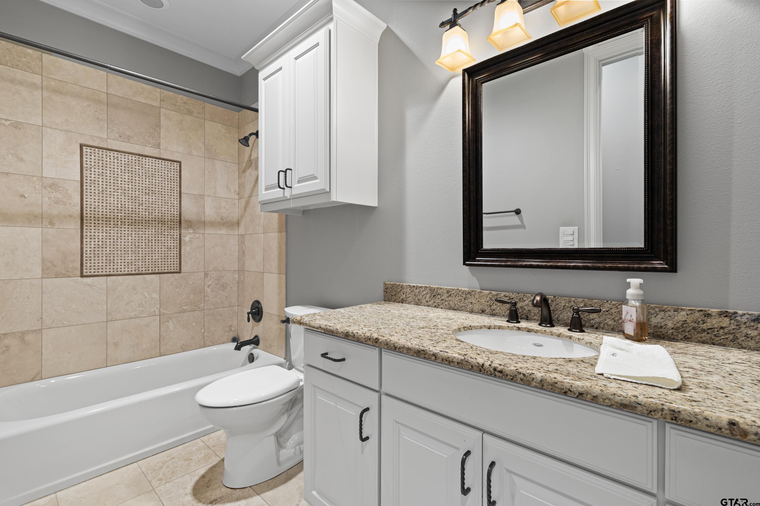 4314 Pecan Ridge Crossing Longview, TX 75605 - Photo 37 of 47 a bathroom with a granite countertop sink mirror vanity and toilet
