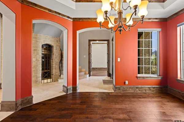 a view of an entryway with wooden floor and door