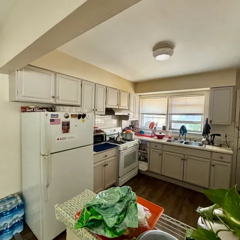a kitchen with granite countertop a sink stainless steel appliances and cabinets