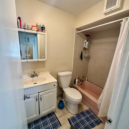a bathroom with a toilet sink and mirror