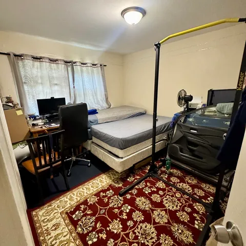 a bedroom with a bed and a dresser