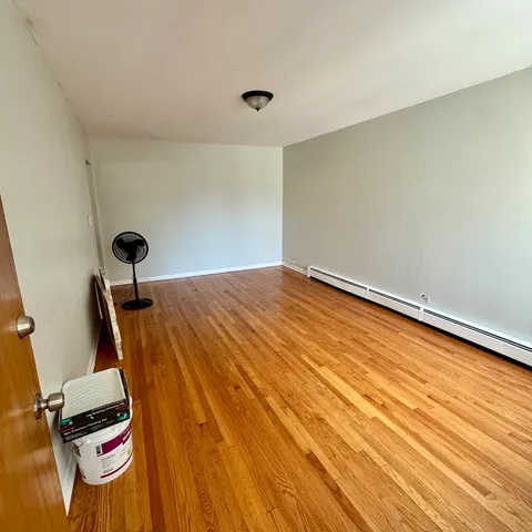 a view of a room with wooden floor