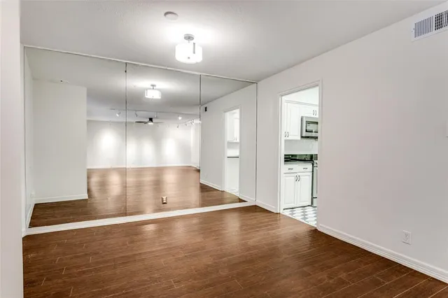 an empty room with wooden floor