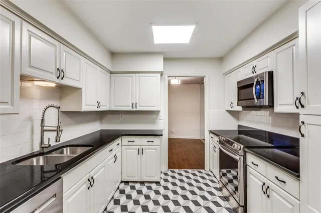 a kitchen with a sink stove and cabinets