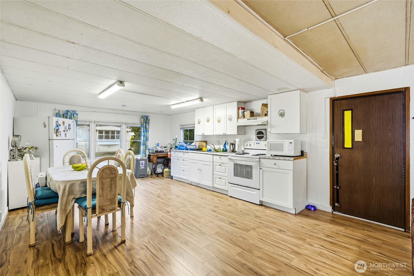 11330 East Riverside Drive, Unit 25 Bothell, WA 98011 - Photo 8 of 19 a kitchen with stainless steel appliances furniture wooden floor and view living room