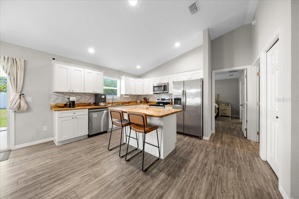 13 Teak Loop Place Ocala, FL 34472 - Photo 19 of 36 a kitchen with white cabinets and stainless steel appliances