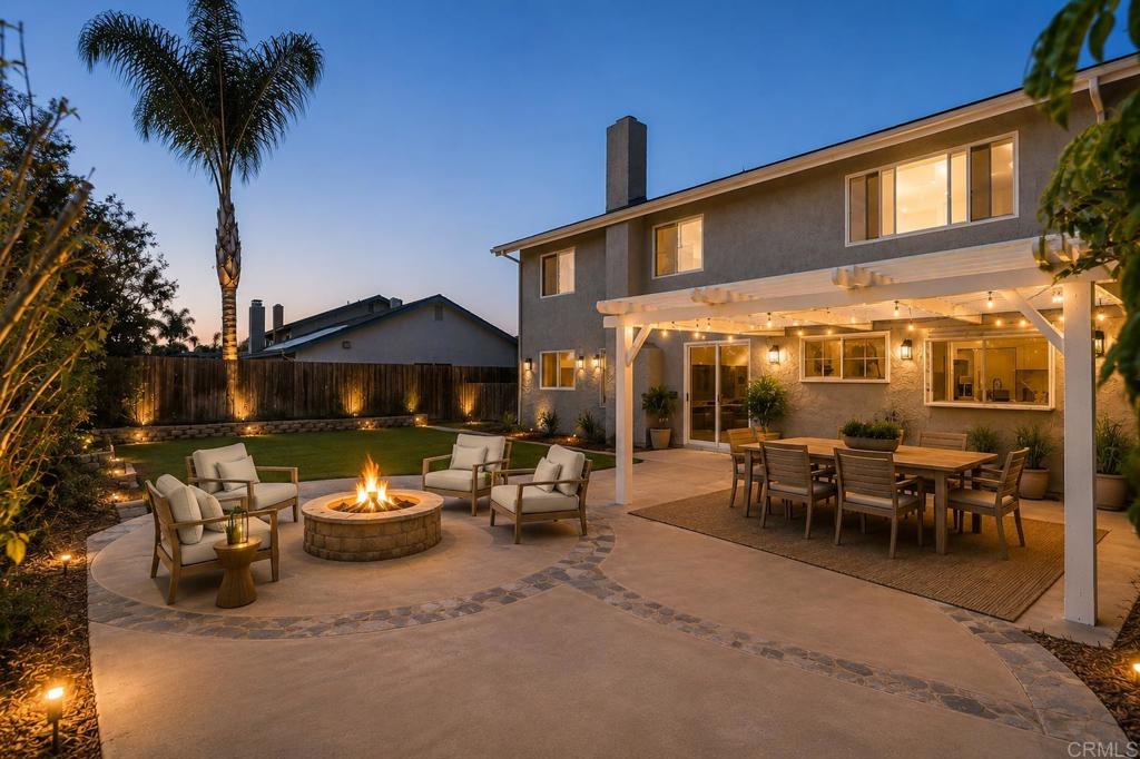 4595 Blackwell Road Oceanside, CA 92056 - Photo 42 of 47 a view of a patio with table and chairs under an umbrella