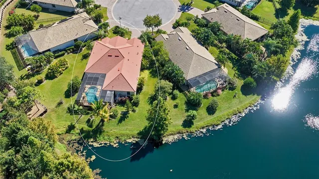 a aerial view of a house with swimming pool and outdoor seating