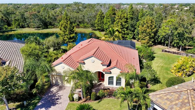 a living room with furniture and floor to ceiling windows