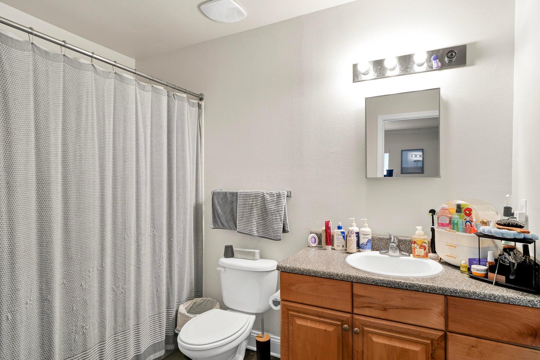 562 Wingspan Way Crestview, FL 32536 - Photo 11 of 12 a bathroom with a sink vanity mirror and toilet