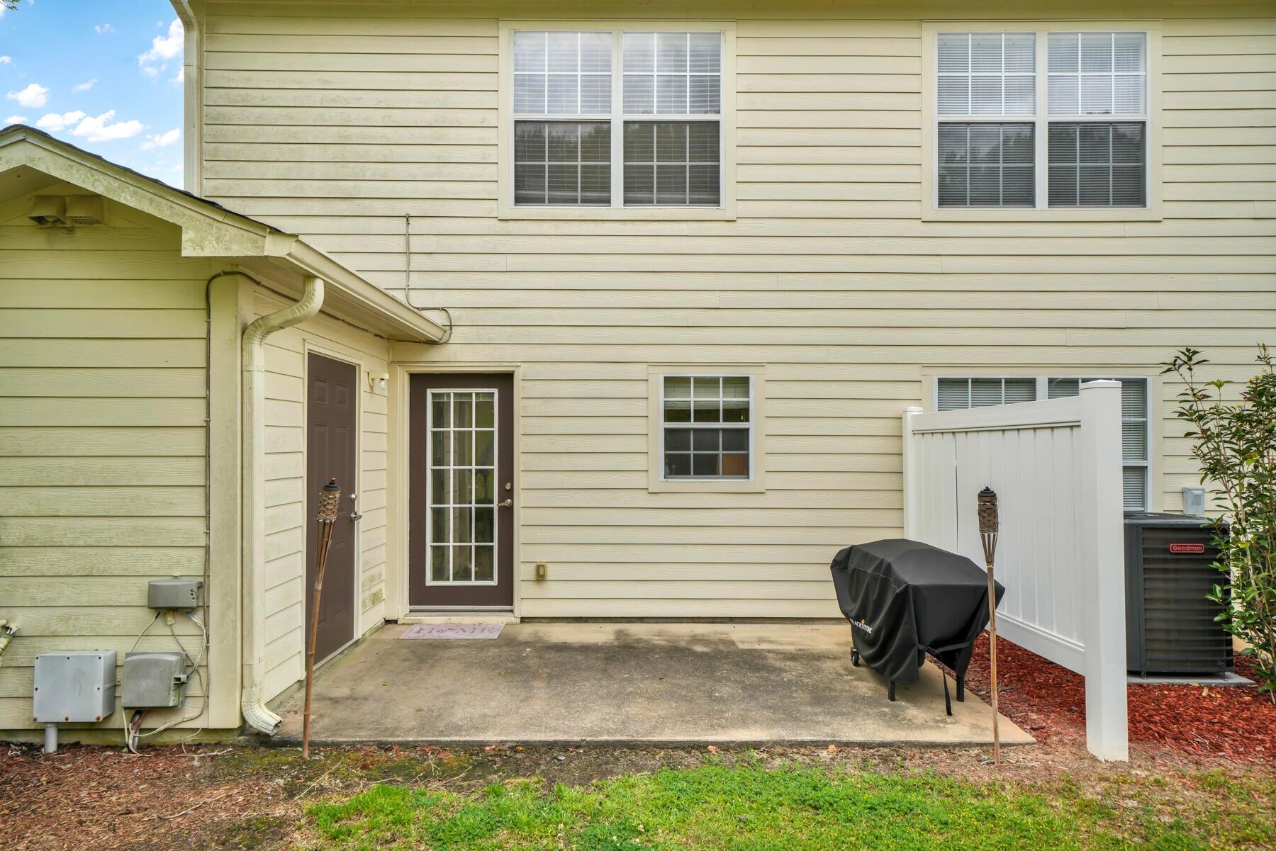 562 Wingspan Way Crestview, FL 32536 - Photo 5 of 12 a view of a house with a patio and a yard