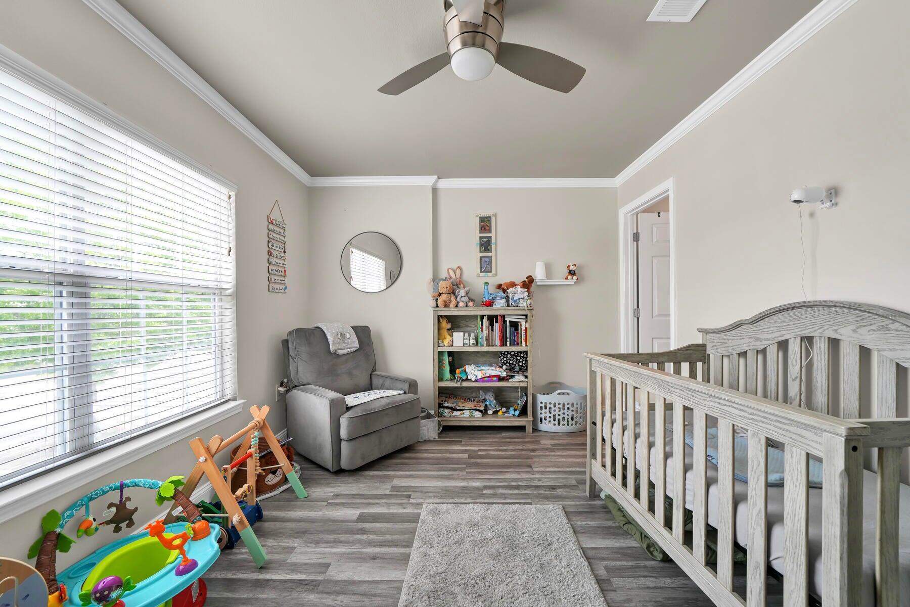 562 Wingspan Way Crestview, FL 32536 - Photo 8 of 12 a bedroom with furniture and a window