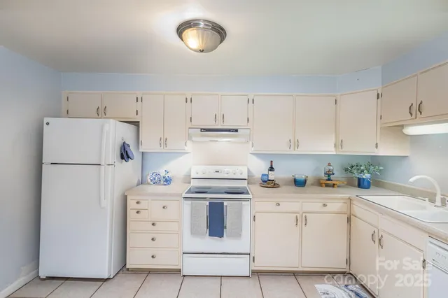 a kitchen with cabinets appliances and a counter space
