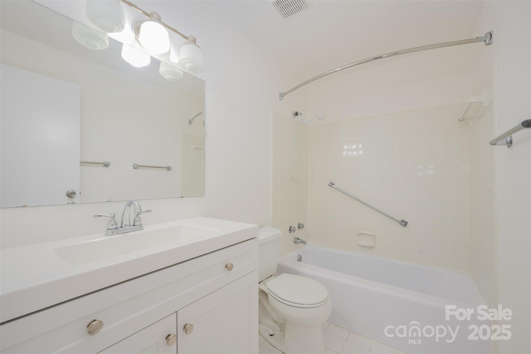 1300 Reece Road, Unit 302 Charlotte, NC 28209 - Photo 14 of 23 a bathroom with a sink a toilet and shower