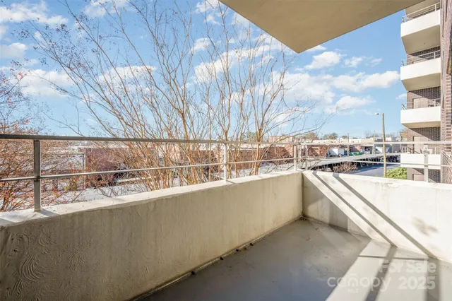 a view of a kitchen with a sink and buildings in the background