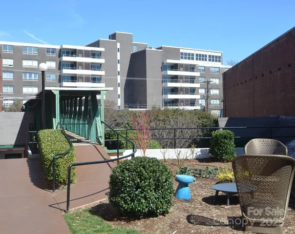 a view of a swimming pool with a garden and trees