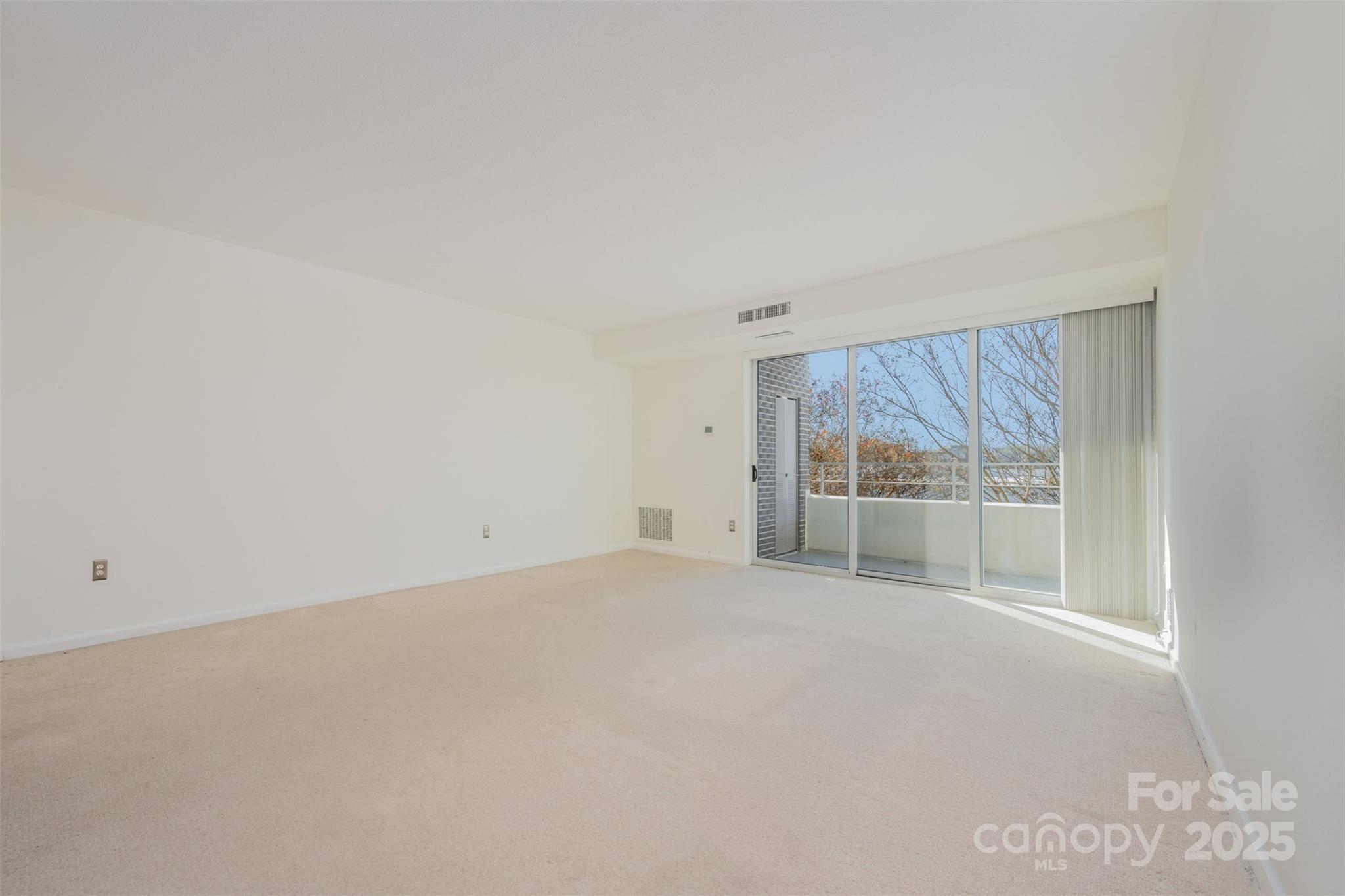 1300 Reece Road, Unit 302 Charlotte, NC 28209 - Photo 6 of 23 a view of empty room with wooden floor and fan