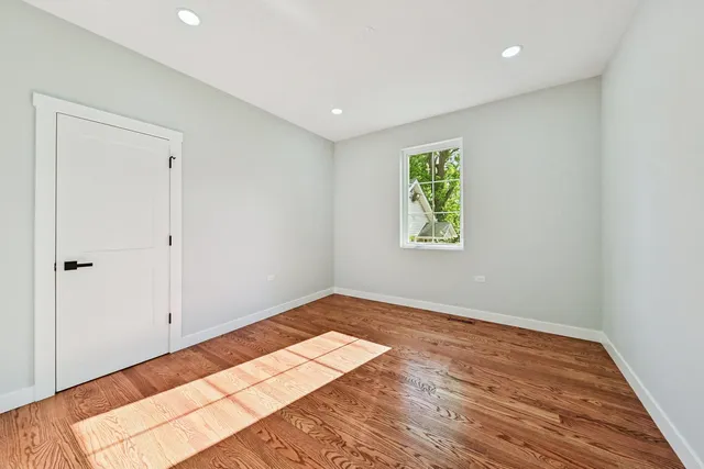 a view of room with window and wooden floor