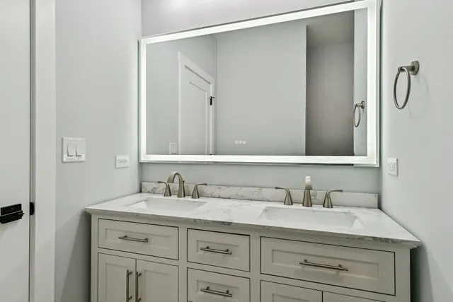 a bathroom with a double vanity sink and a mirror