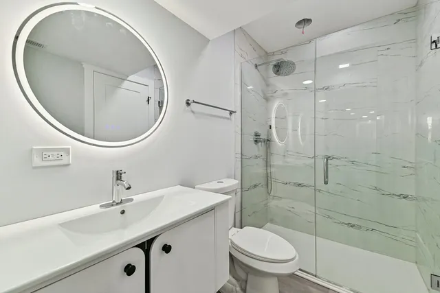 a bathroom with a sink toilet and shower