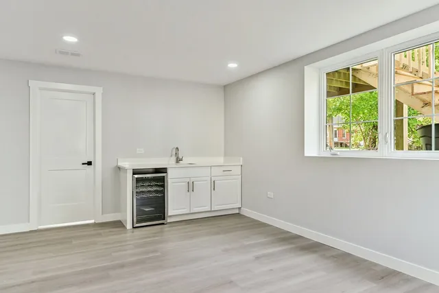 an empty room with a fireplace and wooden floor