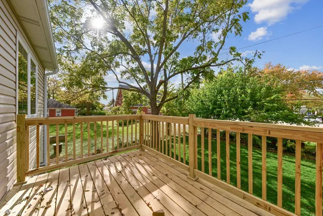 a view of balcony with wooden floor and fence