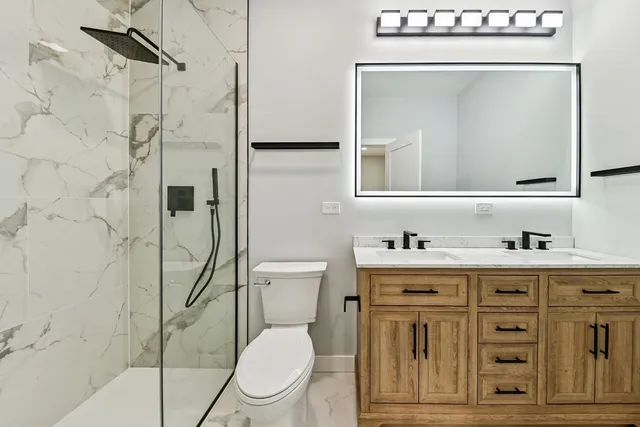 a bathroom with a toilet a sink and mirror