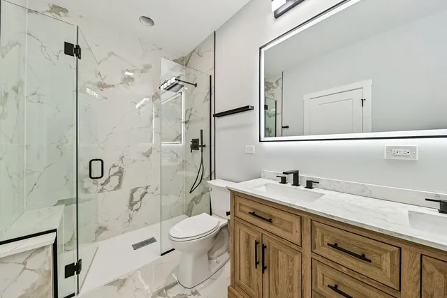 a bathroom with a sink a toilet and shower