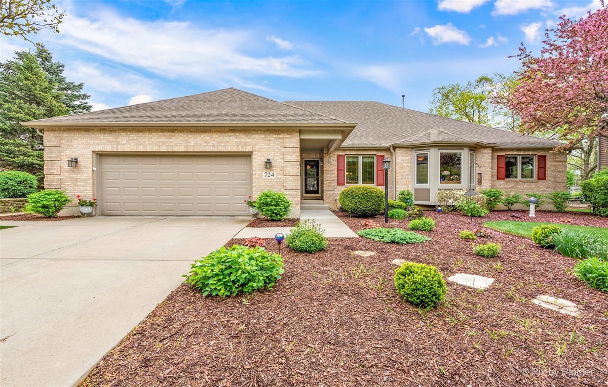 724 Ridgelawn Trail Batavia, IL 60510 - Photo 1 of 32 a front view of a house with a yard and potted plants