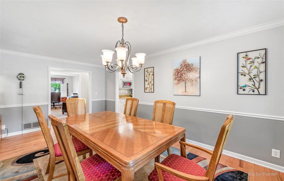 724 Ridgelawn Trail Batavia, IL 60510 - Photo 13 of 32 a view of a dining room with furniture a chandelier and wooden floor