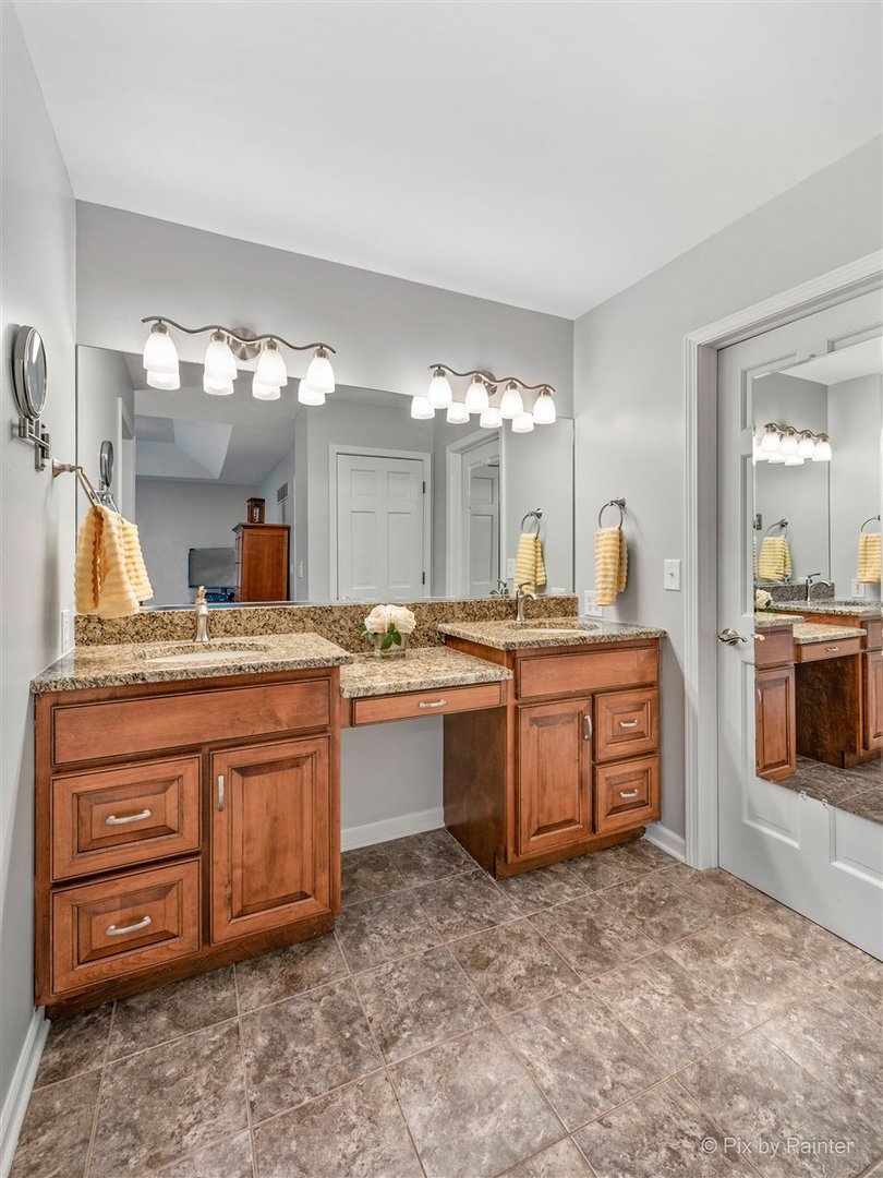 724 Ridgelawn Trail Batavia, IL 60510 - Photo 18 of 32 a large bathroom with a sink and a large mirror