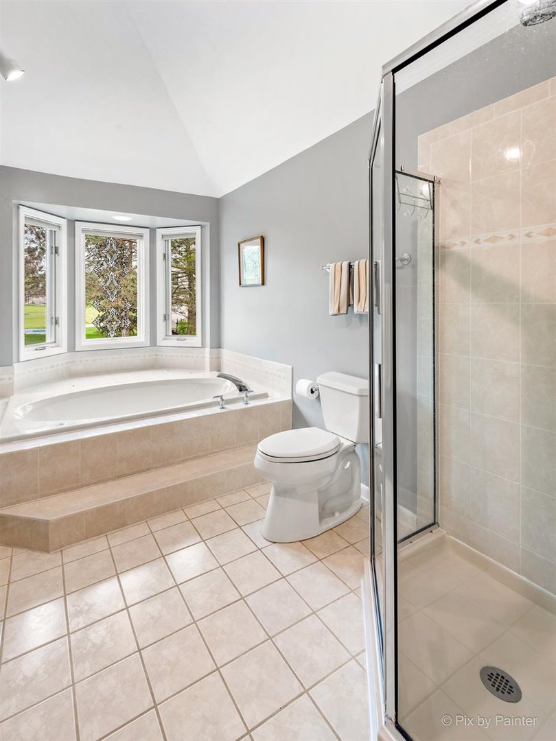 724 Ridgelawn Trail Batavia, IL 60510 - Photo 19 of 32 a spacious bathroom with a bathtub and a shower