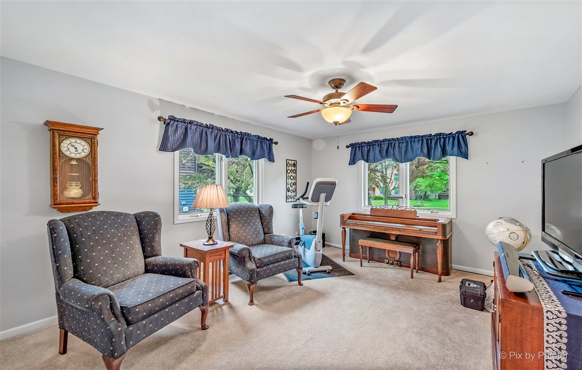 724 Ridgelawn Trail Batavia, IL 60510 - Photo 22 of 32 a living room with furniture a fireplace and a large window
