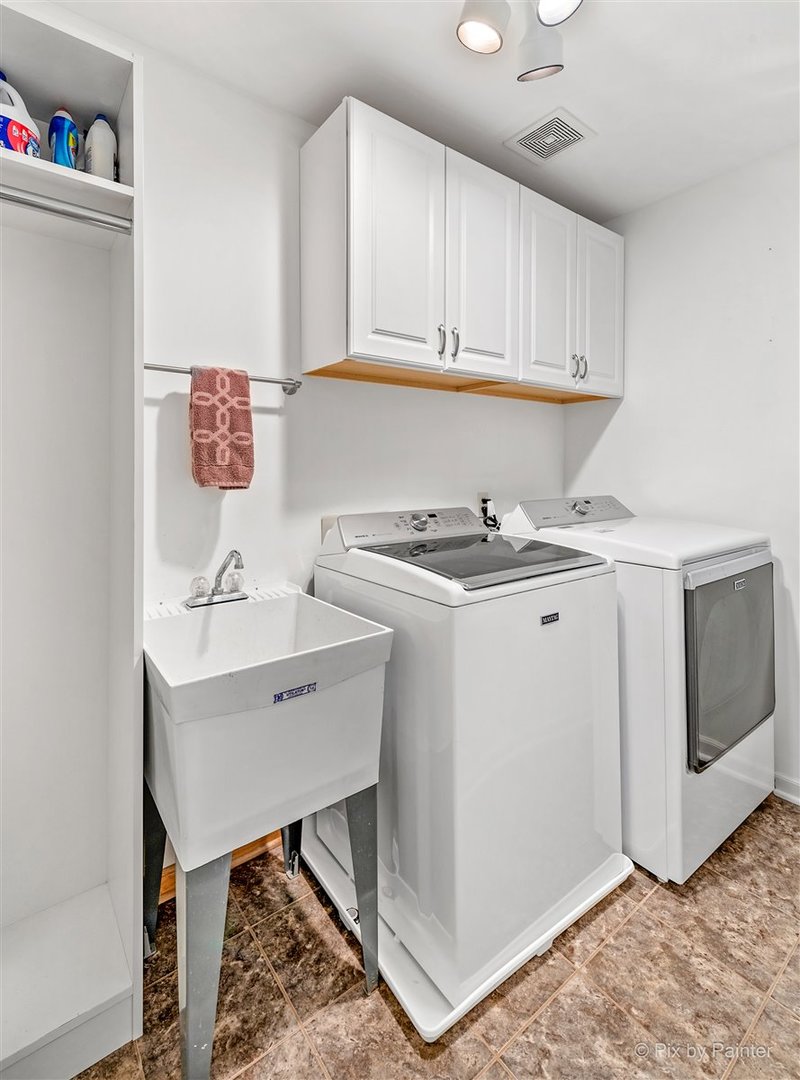 724 Ridgelawn Trail Batavia, IL 60510 - Photo 23 of 32 a utility room with cabinets washer and dryer