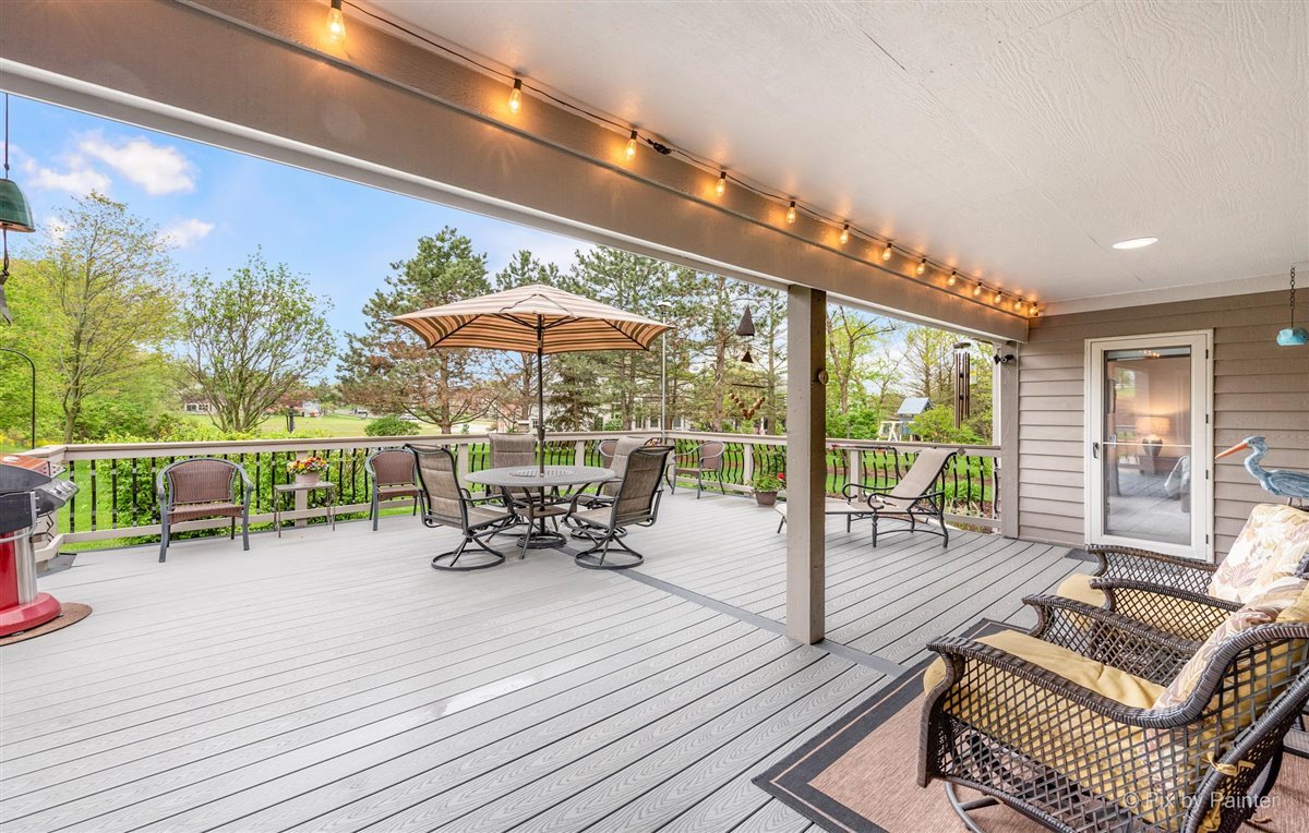 724 Ridgelawn Trail Batavia, IL 60510 - Photo 24 of 32 a view of a patio with a dining table and chairs with wooden floor