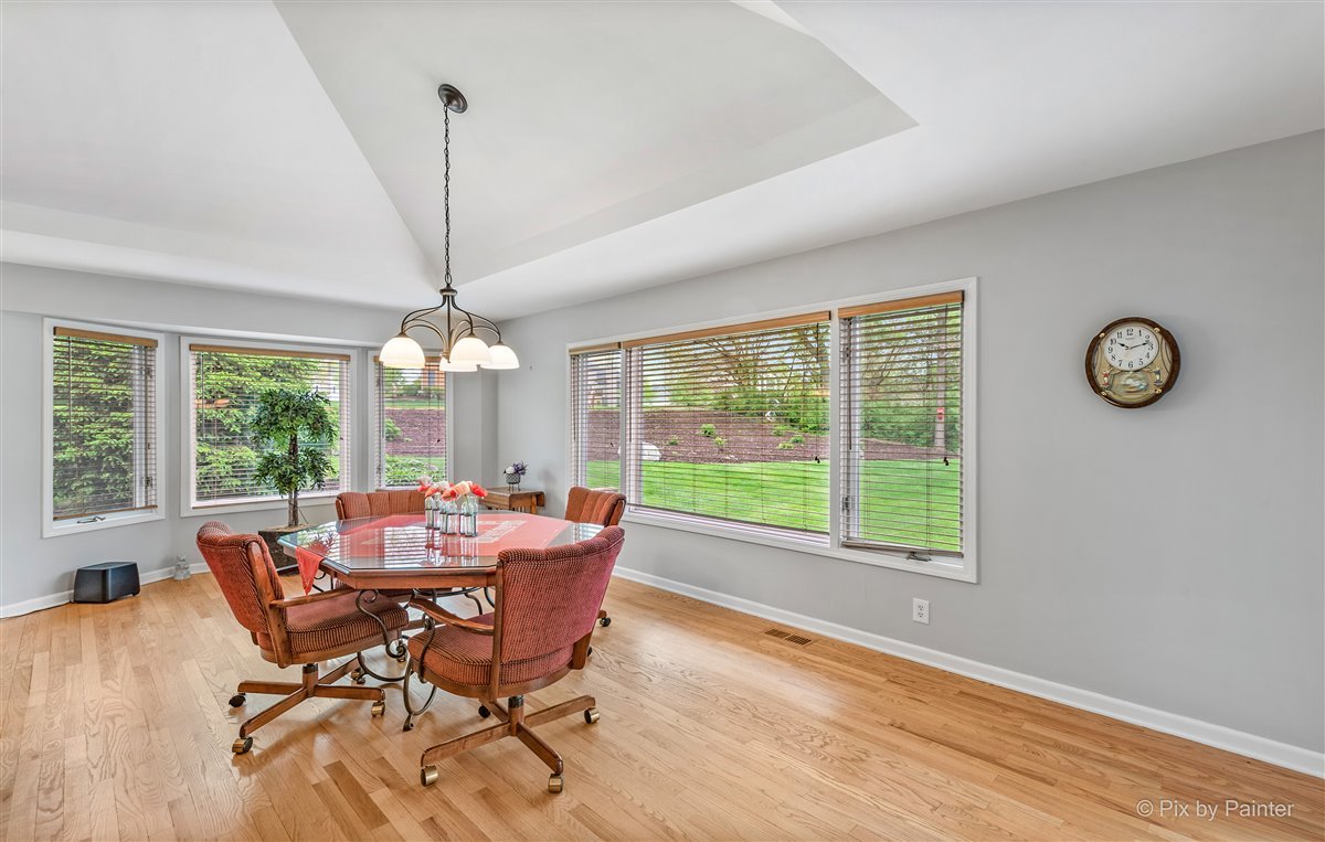 724 Ridgelawn Trail Batavia, IL 60510 - Photo 9 of 32 a dining room with furniture a chandelier and wooden floor
