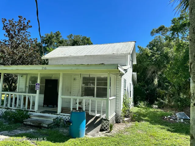 a view of a house with yard and sitting area