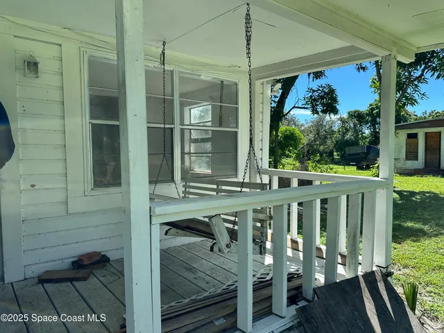 a view of a balcony with wooden floor