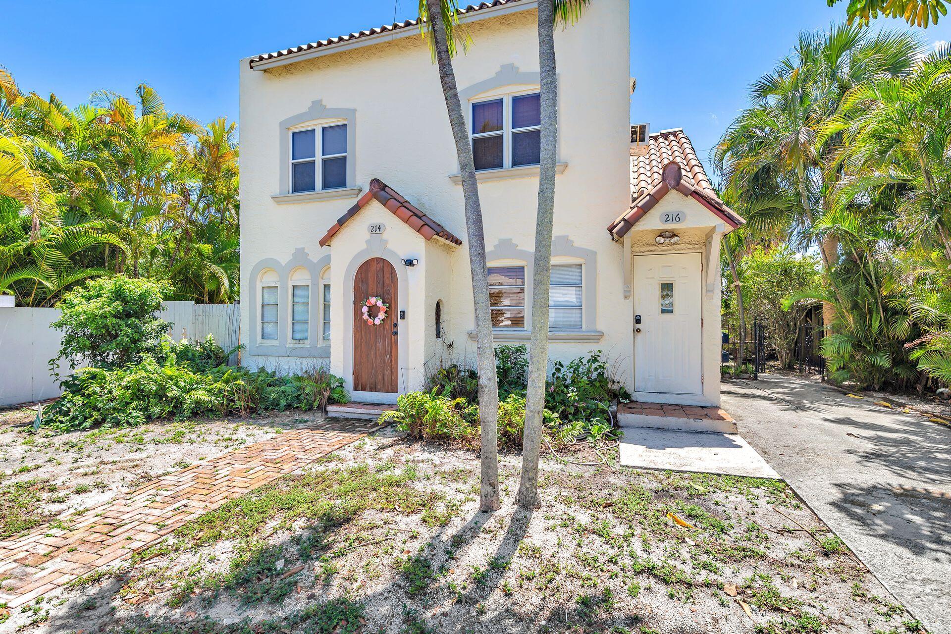 214 Conniston Road West Palm Beach, FL 33405 - Photo 2 of 18 a front view of a house with garden