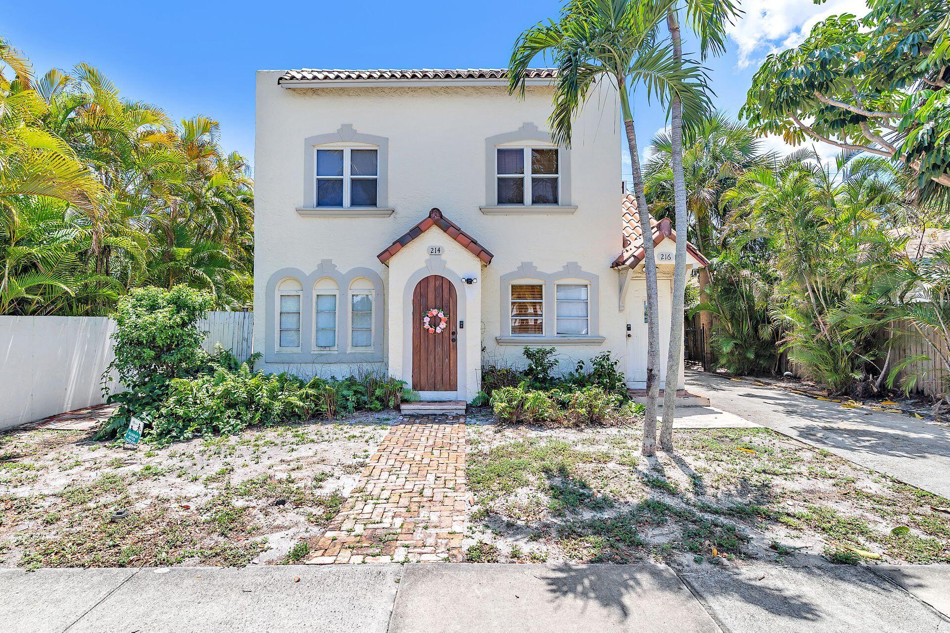 214 Conniston Road West Palm Beach, FL 33405 - Photo 3 of 18 a front view of a house with garden