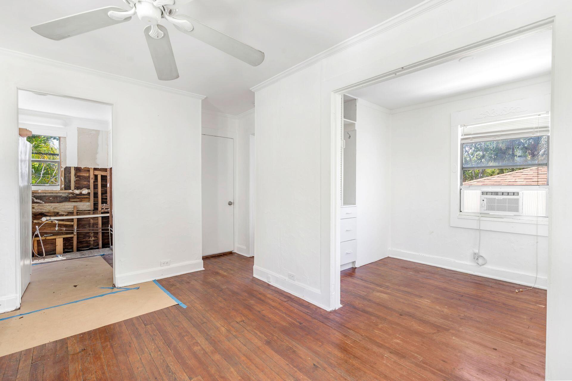 214 Conniston Road West Palm Beach, FL 33405 - Photo 5 of 18 a view of empty room with wooden floor and fan