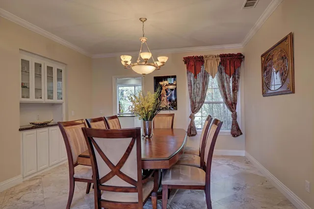 a view of a dining room with furniture and chandelier