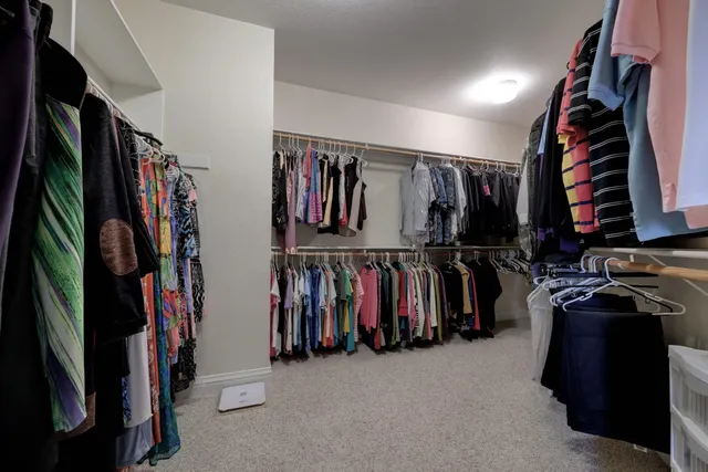 a bedroom with a bed and a potted plant