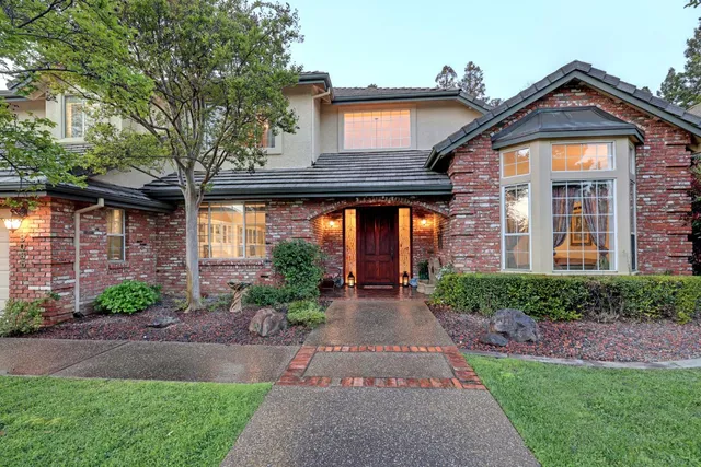 a front view of a house with a yard