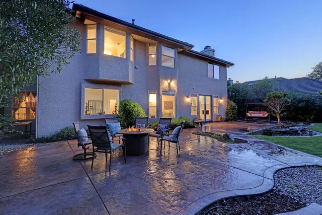 a view of a backyard with plants and patio