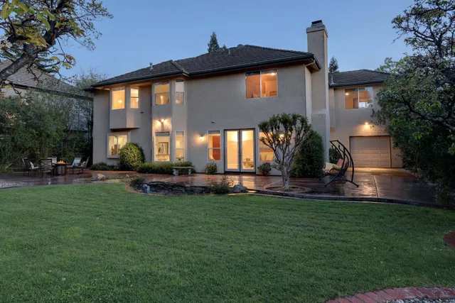 a view of a street with a bench and trees