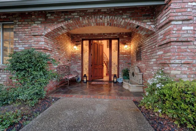 a view of a porch with a table and chairs